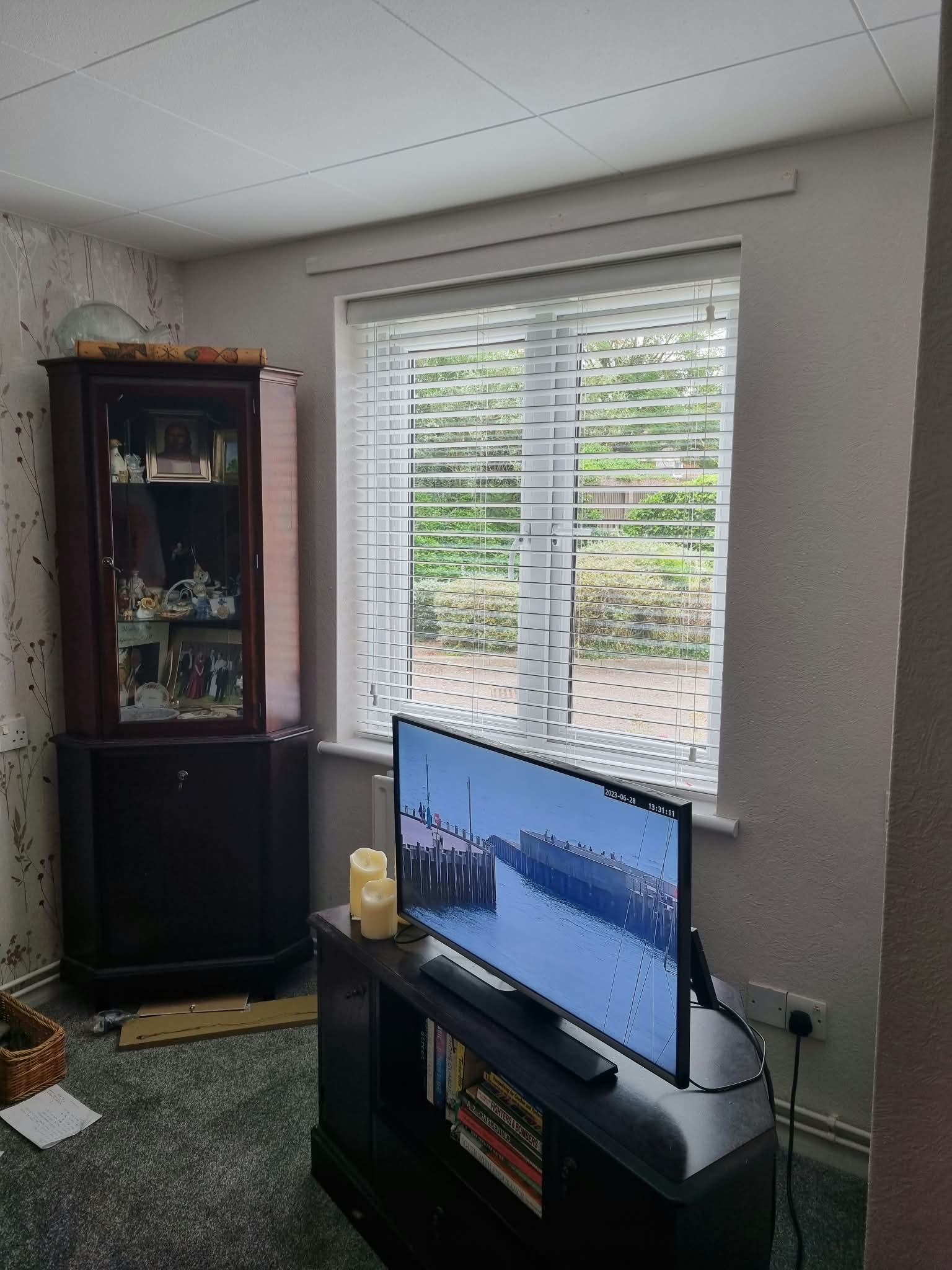 Blinds in a living room with display cabinet — Sustainable Shutters & Blinds