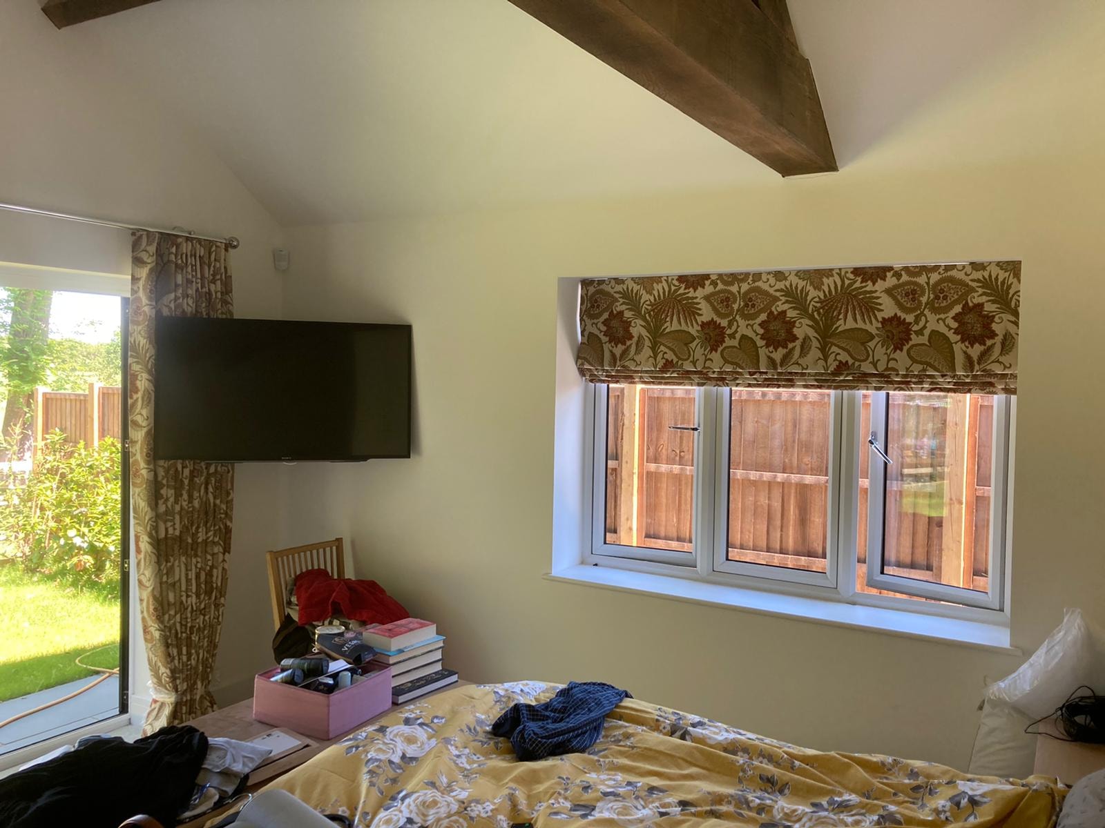 Roman blind in a bedroom — Sustainable Shutters & Blinds