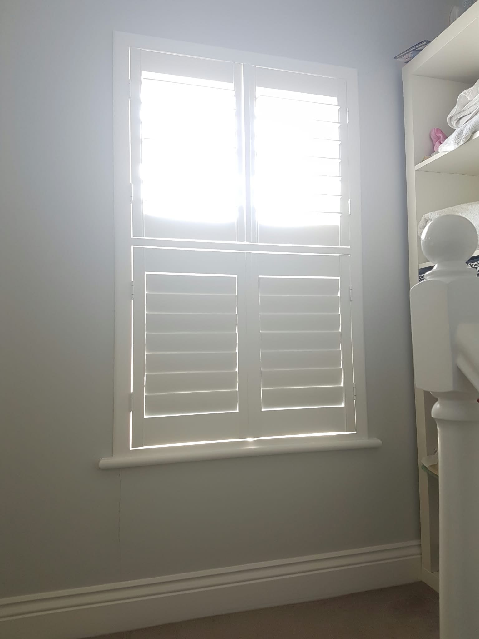 White shuttered window in a bright bathroom — Sustainable Shutters & Blinds