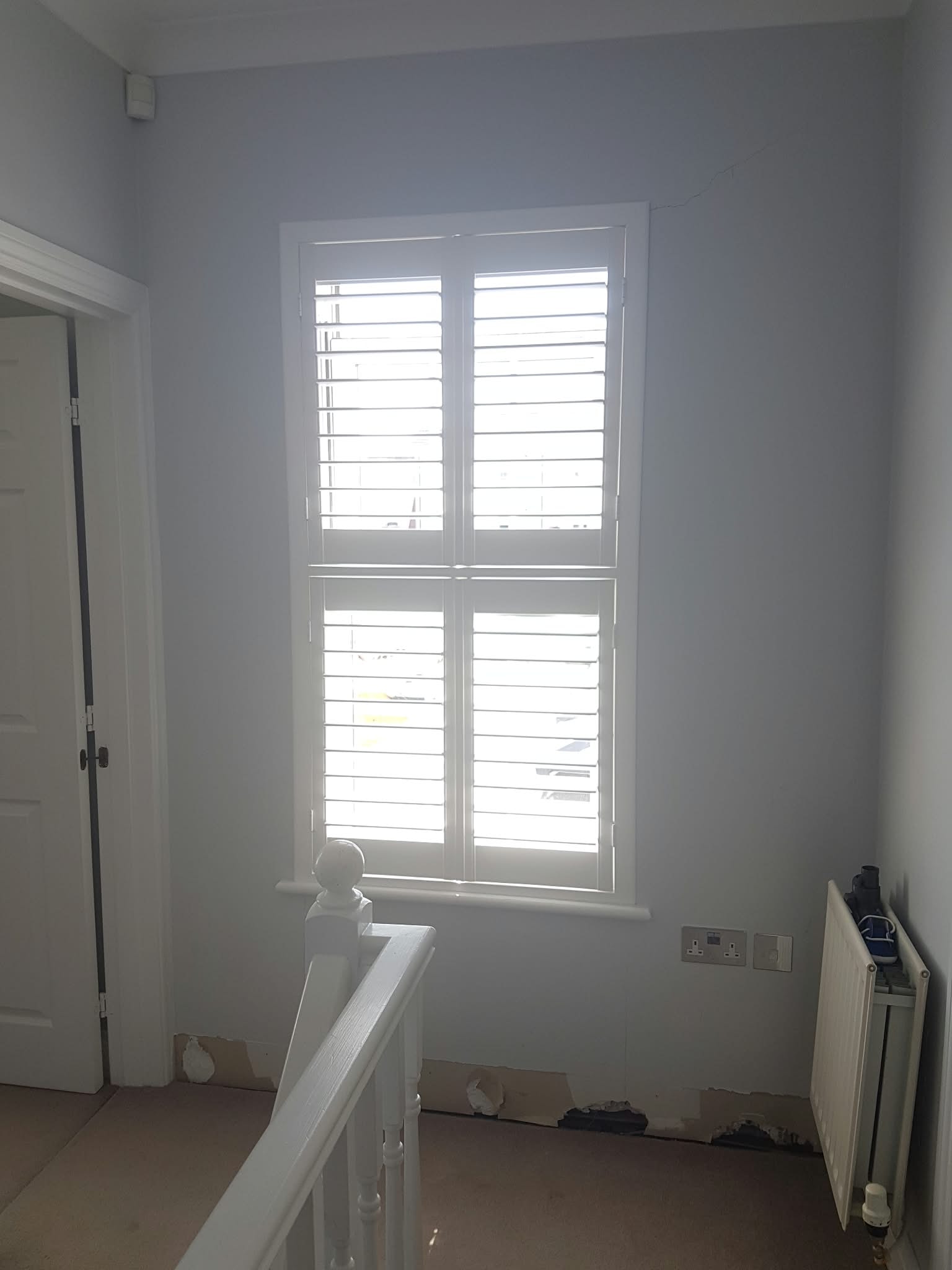 Shutters on a landing window — Sustainable Shutters & Blinds