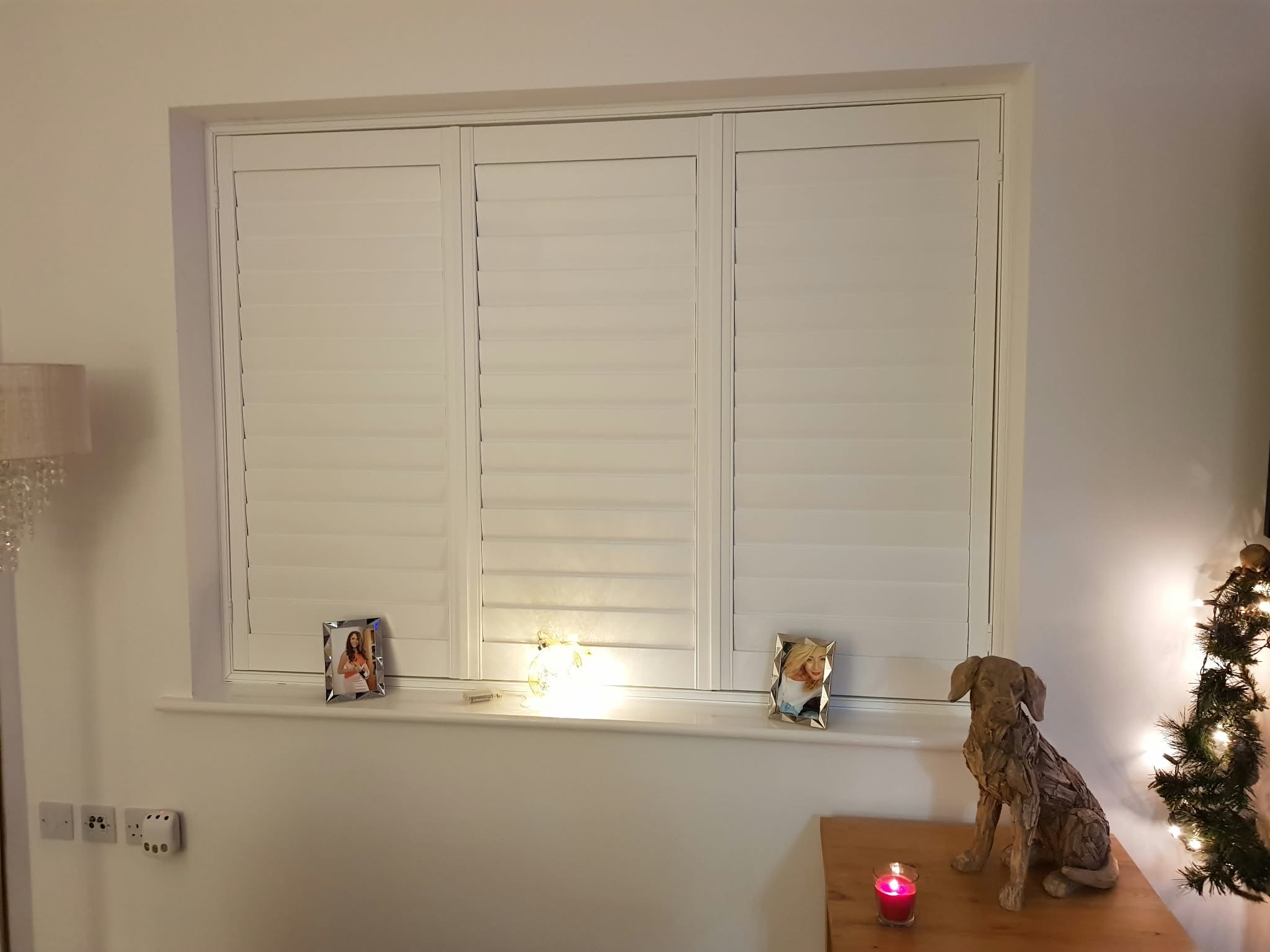 White shutters close-up in a living room — Sustainable Shutters & Blinds