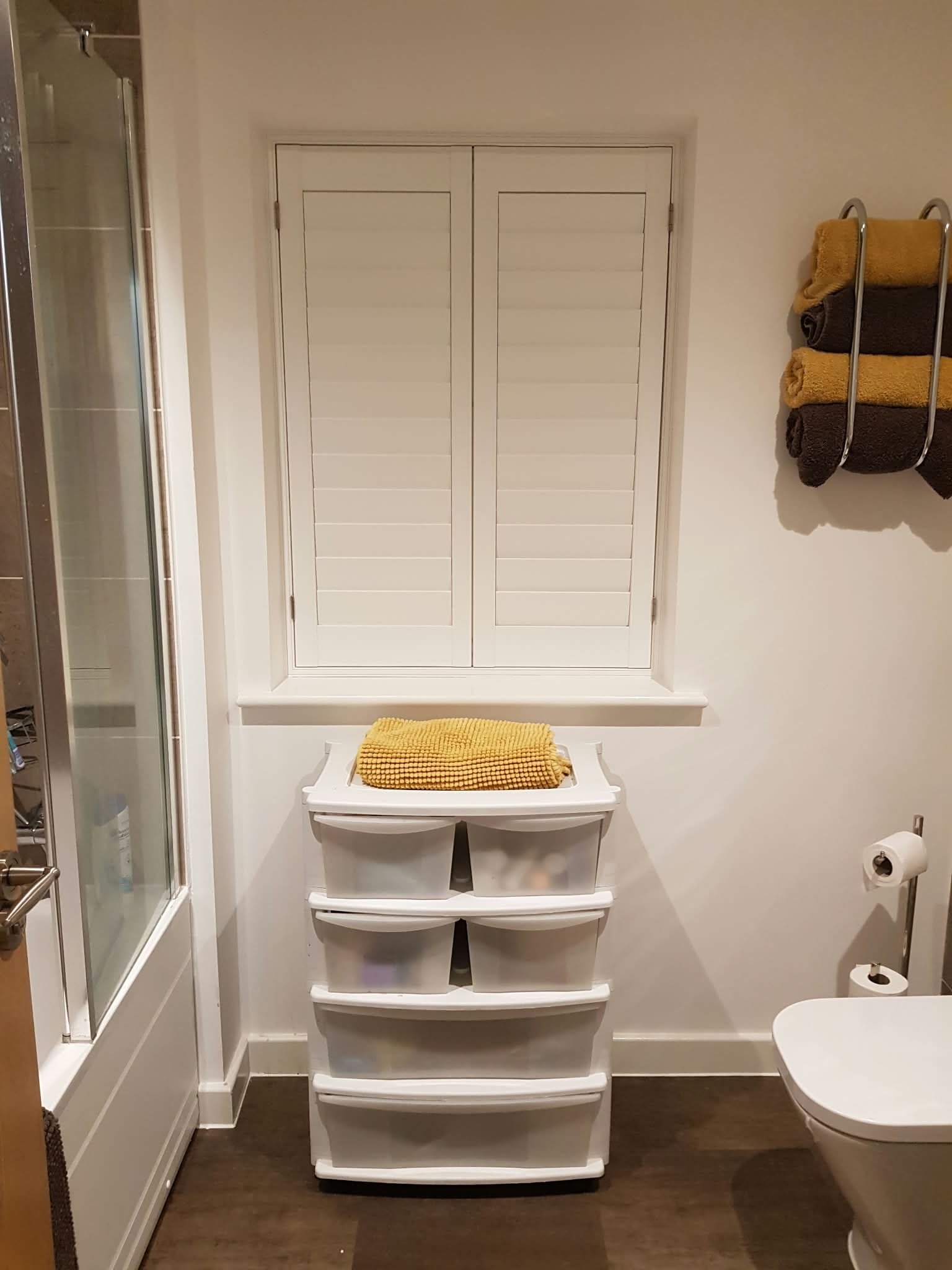 White shutters in a bathroom — Sustainable Shutters & Blinds
