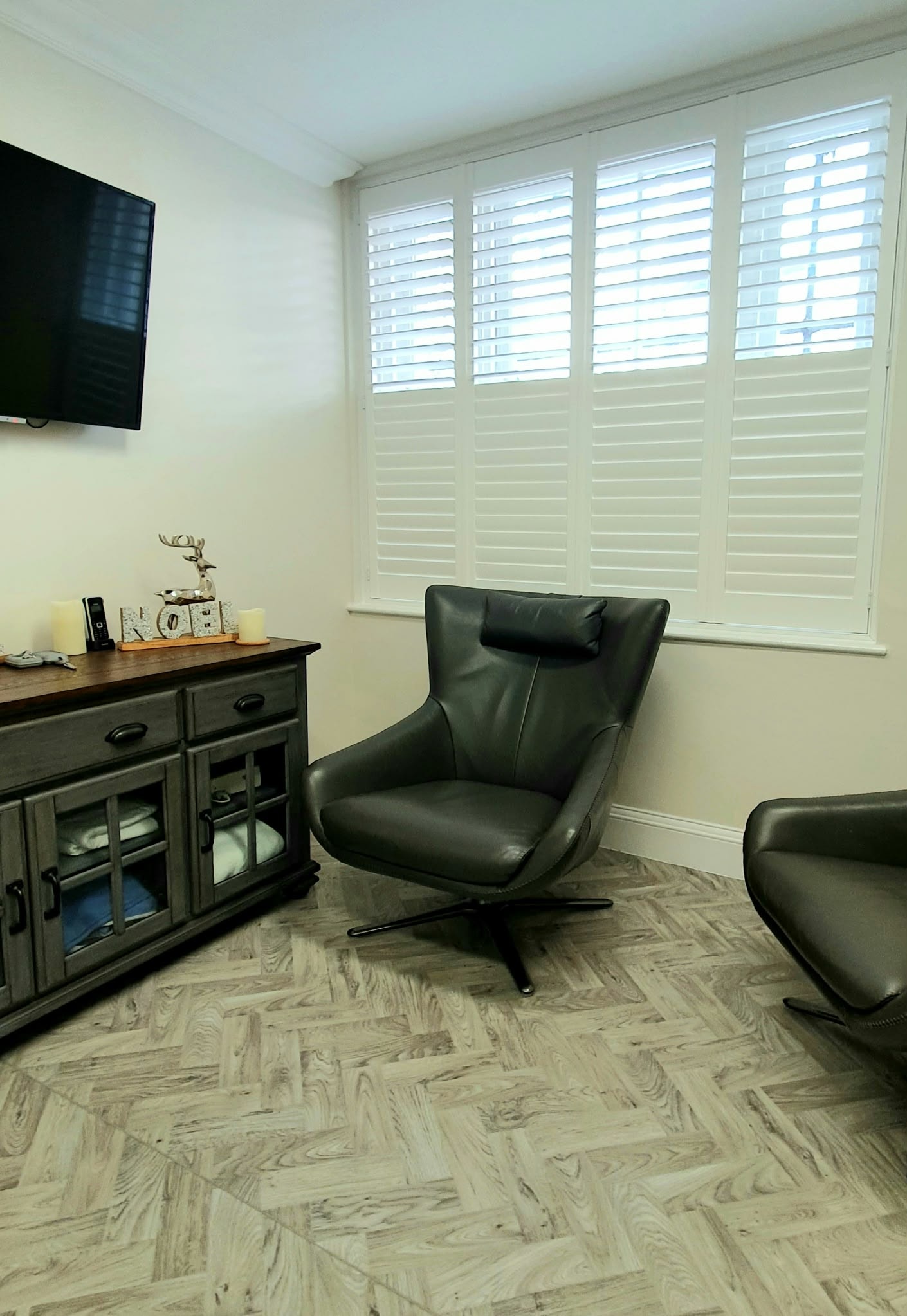 White shutters in a treatment room with chandelier — Sustainable Shutters & Blinds