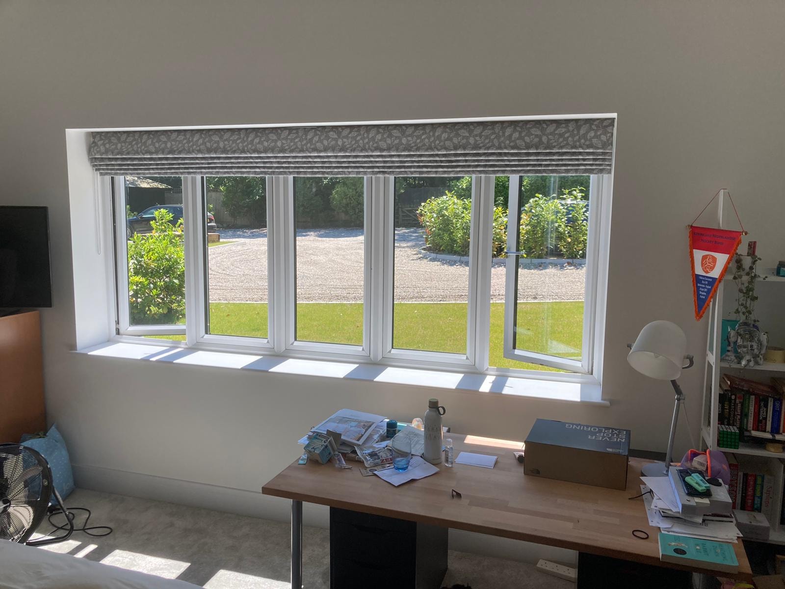 White shutters on a curved five-panel bay window — Sustainable Shutters & Blinds