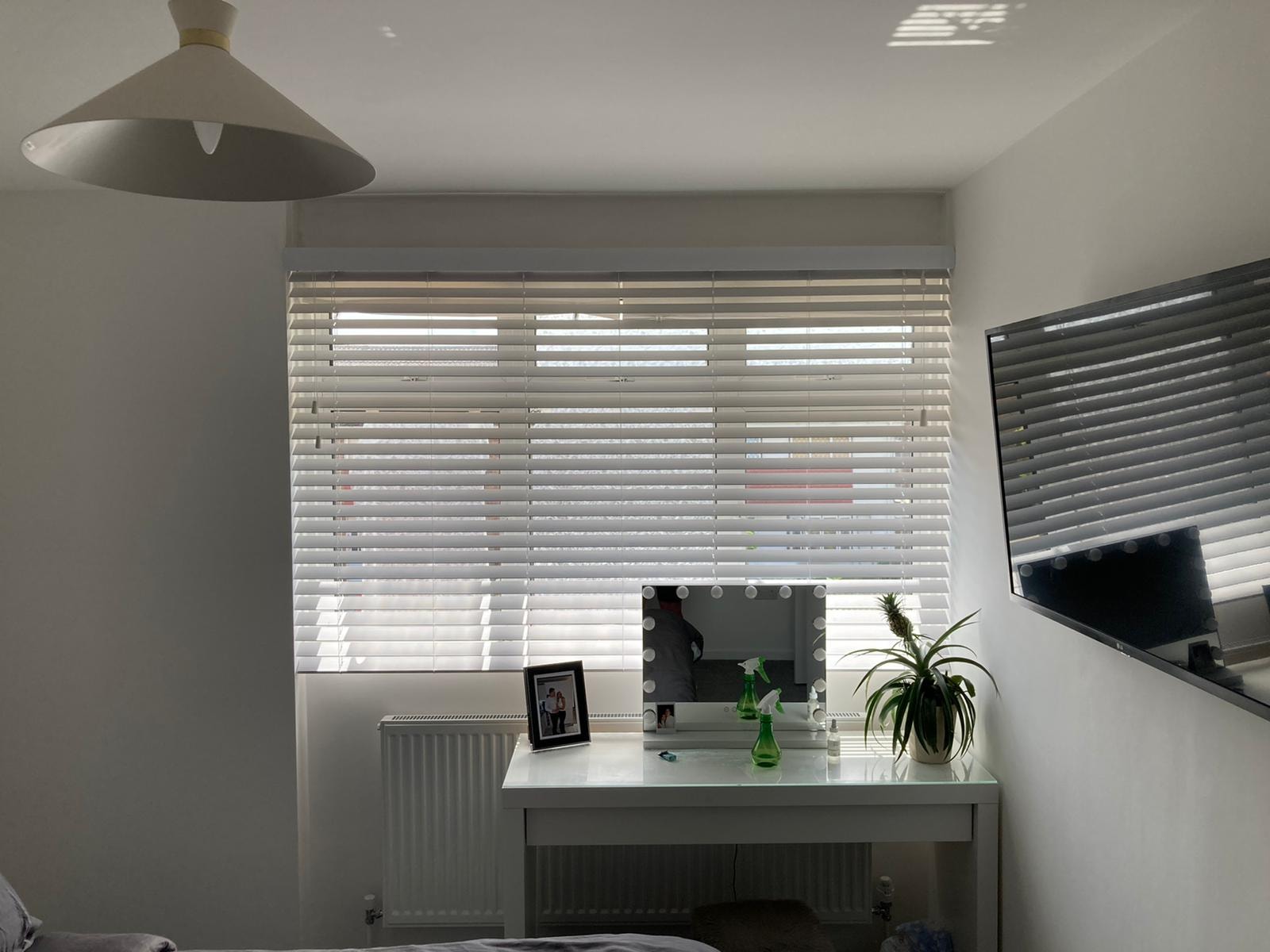 Navy wave curtains close-up with pendant lights — Sustainable Shutters & Blinds